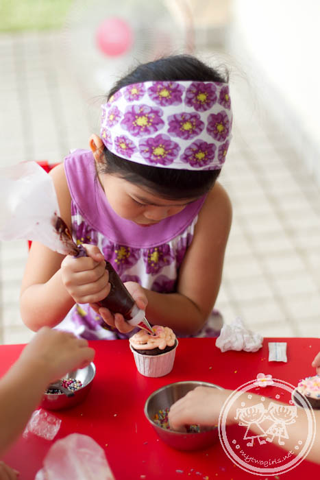 Ashley decorating cupcakes